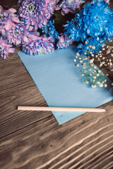 Violet, blue and pink chrysanthemum. A bouquet of chrysanthemums on wooden background with copy space. Chrysanthemum Flower Close up.