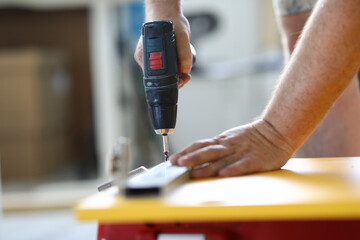Hand with screwdriver fasten details with close-up