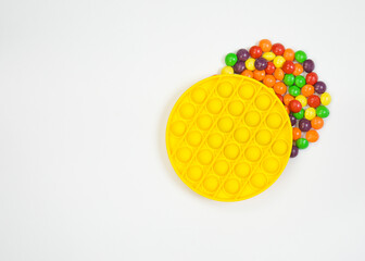 Yellow popit fidget. Sensory anti stress toy. Simple dimple with colourful sweets, candies. New trend.