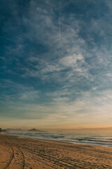 Incredible dawn on a Brazilian beach with blue sky amid clouds and rising sun in the morning