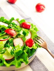 Healthy salad of fresh vegetables and lettuce leaves. Vegetarian healthy food concept.