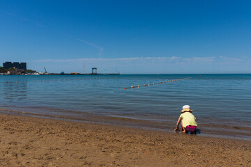 Anapa. Krasnodar Region - May 14, 2021: a child plays on the Black Sea coast