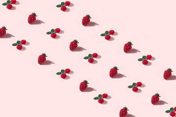 Creative pattern with strawberries and cherries against pastel background. Trendy minimal aestehtic. Summer fruit concept.