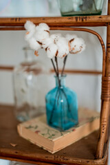 Cotton flower inblue glass vase close up, home decor