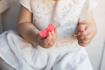 baby holding a flower