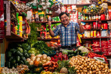 Grocery store in Guatemala with successful man celebrating, standing in a boxing position.