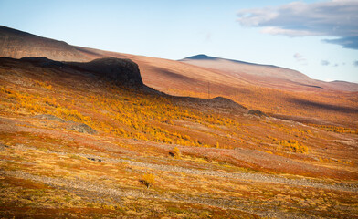 A faraway view of Kebnekaise Mountain Station, strange shadows from the clouds at sunset, Lapland, Sweden, September 2020