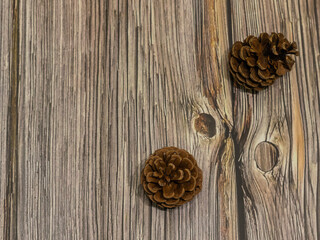 wooden background with pine cones