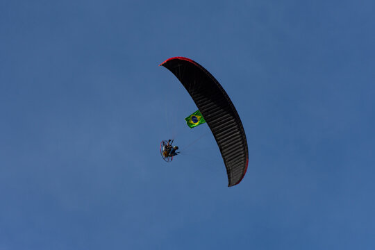 paraglider in the sky with Brazilian flag