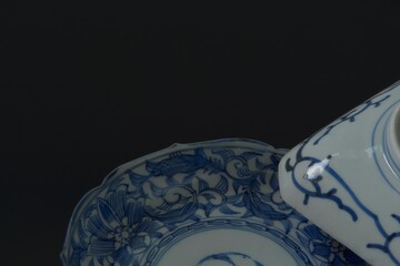 Lay out of picture plate. This is a very fine example of Japanese traditional antique “ imari ware ”.  black background・dim lighting soft focus image.