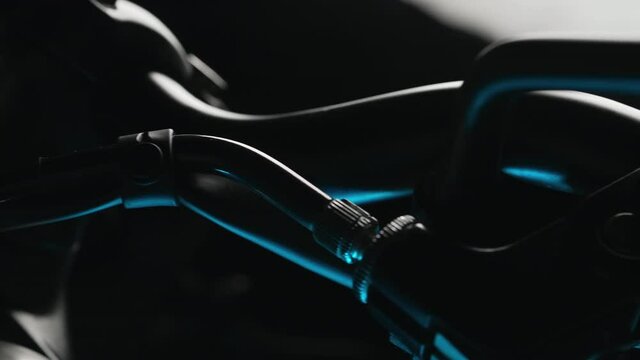 Steering wheel of classic cafe racer on dark background. Motorcycle aesthetics and retro design concept. Dolly-shot 