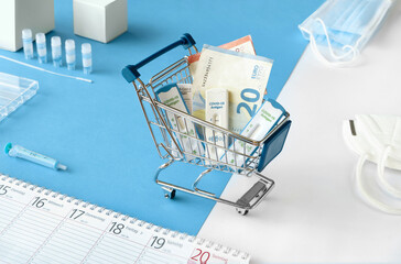Cost of shnelltest, rapid corona test in German language. Shopping cart with covid 19 antigen tests...