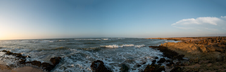 Fototapeta na wymiar Panoramic View of the Sea Waves Crashing Against the Rocks on the Shore at Punta Gallinas (Cape Gallinas, 