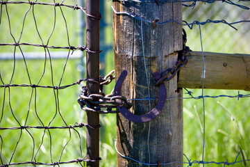 Horseshoe lock on a barbed wire fence in The West in Robertson, Wyoming and the ranches in the Bridger Valley. 