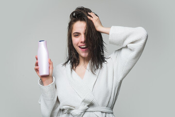Health hair and beauty concept. A beautiful young girl in the studio with wet hair with balm...