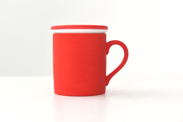 beautiful ceramic teapot mug in red color on white background