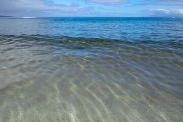 Summer vacation at a tropical beach. Paradise beach with sand and clear water of the sea. Ocean beach background.