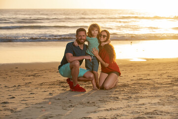 Happy family hugging on beach. Family outdoors.