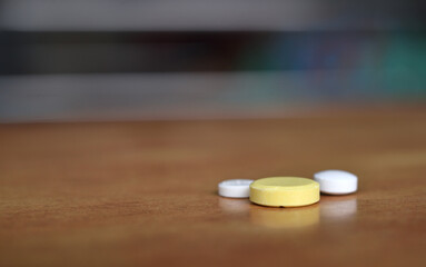 Fototapeta na wymiar Close Up Capsule Pills on Wooden Table with Shallow Depth of Field