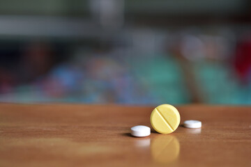 Close Up Capsule Pills on Wooden Table with Shallow Depth of Field