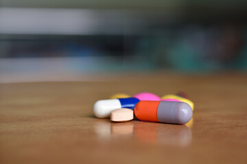 Close Up Capsule Pills on Wooden Table with Shallow Depth of Field