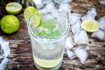 Making a margarita cocktail lime salt and mint leaves