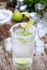 Making a margarita cocktail lime salt and mint leaves