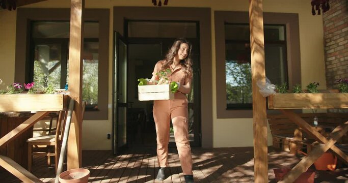 Young mixed race couple prepare to plant and talk in front of their house. African man and latin woman gardeners grow organic food