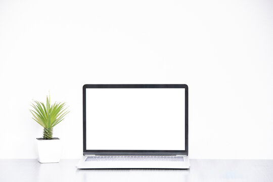 Laptop on table with white background