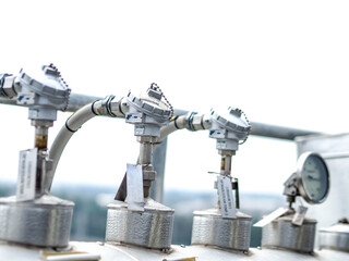 Temperature sensor for measuring instrument close up in industry zone at power plant.