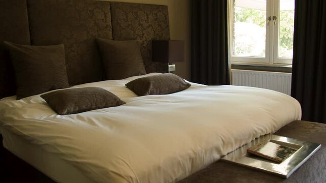 Dolly of beautiful double bed in hotel room