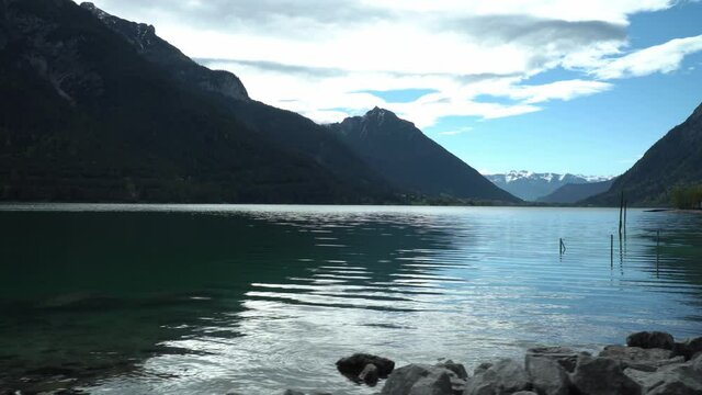 Water reflection on lake Achen in tyrolean Alps, surrounded by amazing mountains.