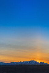 Fototapeta premium Beautiful sunset in mountains, in Kosh-Agach, Altai Republic, Russia. Bright sun and blue sky