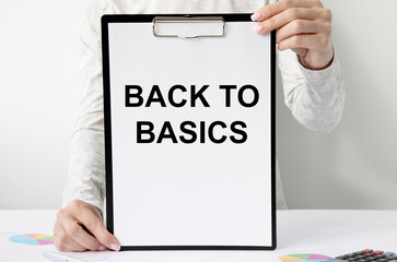 The girl with two hands in front of her holds a tablet for the letter with the text Back to Basics.