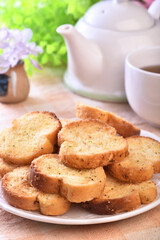 Round rusks with pesto sauce flavor on white plate  