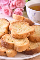 Round rusks with pesto sauce flavor on white plate  