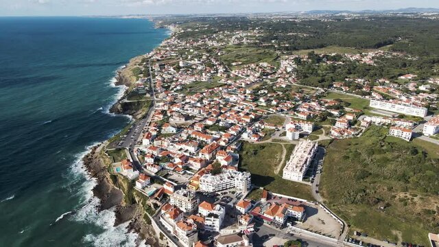 Aerial view of Praia das Macas little township along south Portuguese coastline facing the Atlantic Ocean, Colares, Portugal.