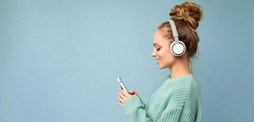 Panoramic Side-profile photo shot of beautiful joyful smiling young female person wearing stylish...