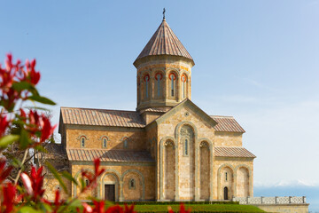 Obraz premium Impressive building of new Cathedral of Agia Nina at Bodbe Convent in foothills of Caucasus Mountains on sunny spring day, Kakheti, Georgia
