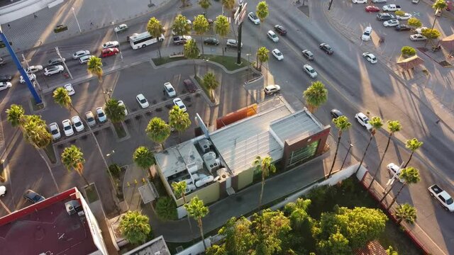Drone aerial view of intersection of streets or road highways in a busy car traffic modern city at summer time