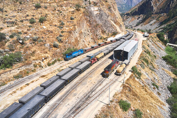 Aerial view of several railway wagon trains with goods at the railway station, Aerial view. Matucana - Peru