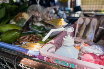 Bottle of alcohol gel for washing hands to prevent coviral-19 of the food truck selling fresh food market on truck in Thailand.