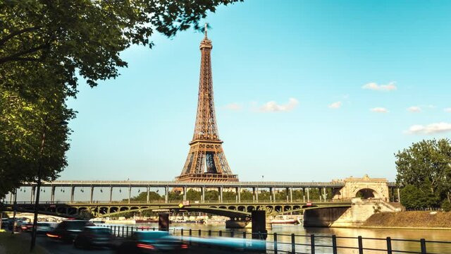 Traffic in paris in timelapse, cars Metro train over Bir-Hakeim bridge between two stations Bir-Hakeim and passy near the Eiffel Tower over the river Seine in sunny day