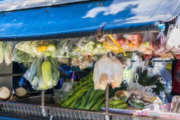 Supermarket on mobile truck or pickup truck,dealer,delivery shopping.Fresh vegetables,fruits and everything food in packaging in plastic bag and hanging for customers to buy,Bangkok, Thailand