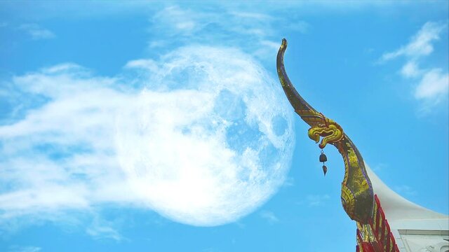 full moon with Cho fa thai language call it, like finial on the roof ridge and heap beautiful white cloud clear blue sky huge moving