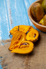 Egg fruit Canistel Yellow Sapote (Pouteria campechiana (Kunth) Baehni) on blue wooden table
