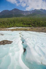 Snow and ice on the banks of the river Hoisey. Polar day on Putorana Plateau, Russia