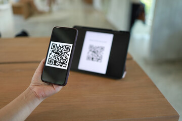 Qr code payment. Woman scanning QR code online shopping cashless technology concept.