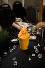 Naklejka na ściany i meble mango smoothie served on black table at cafe​
