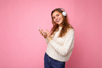 Photo of beautiful joyful smiling young woman wearing stylish casual clothes isolated over...